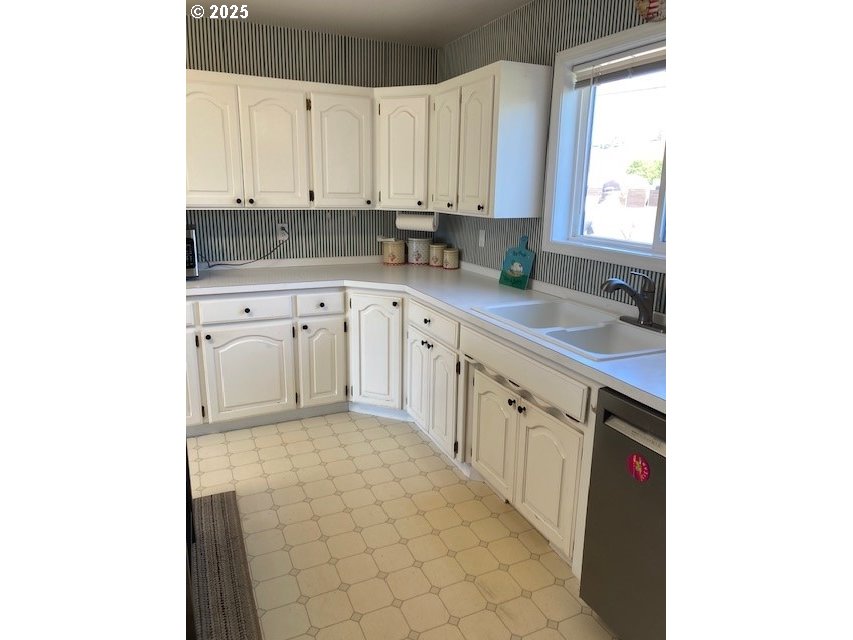 3202 Northeast Riverside Avenue Pendleton, OR 97801 - Photo 6 of 22 a kitchen with stainless steel appliances granite countertop a sink and dishwasher a stove top oven with granite countertops