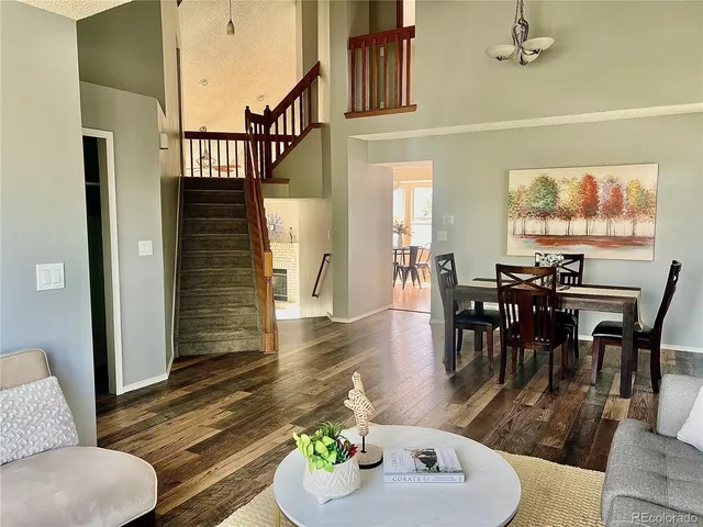 a living room with furniture pool table and a large window