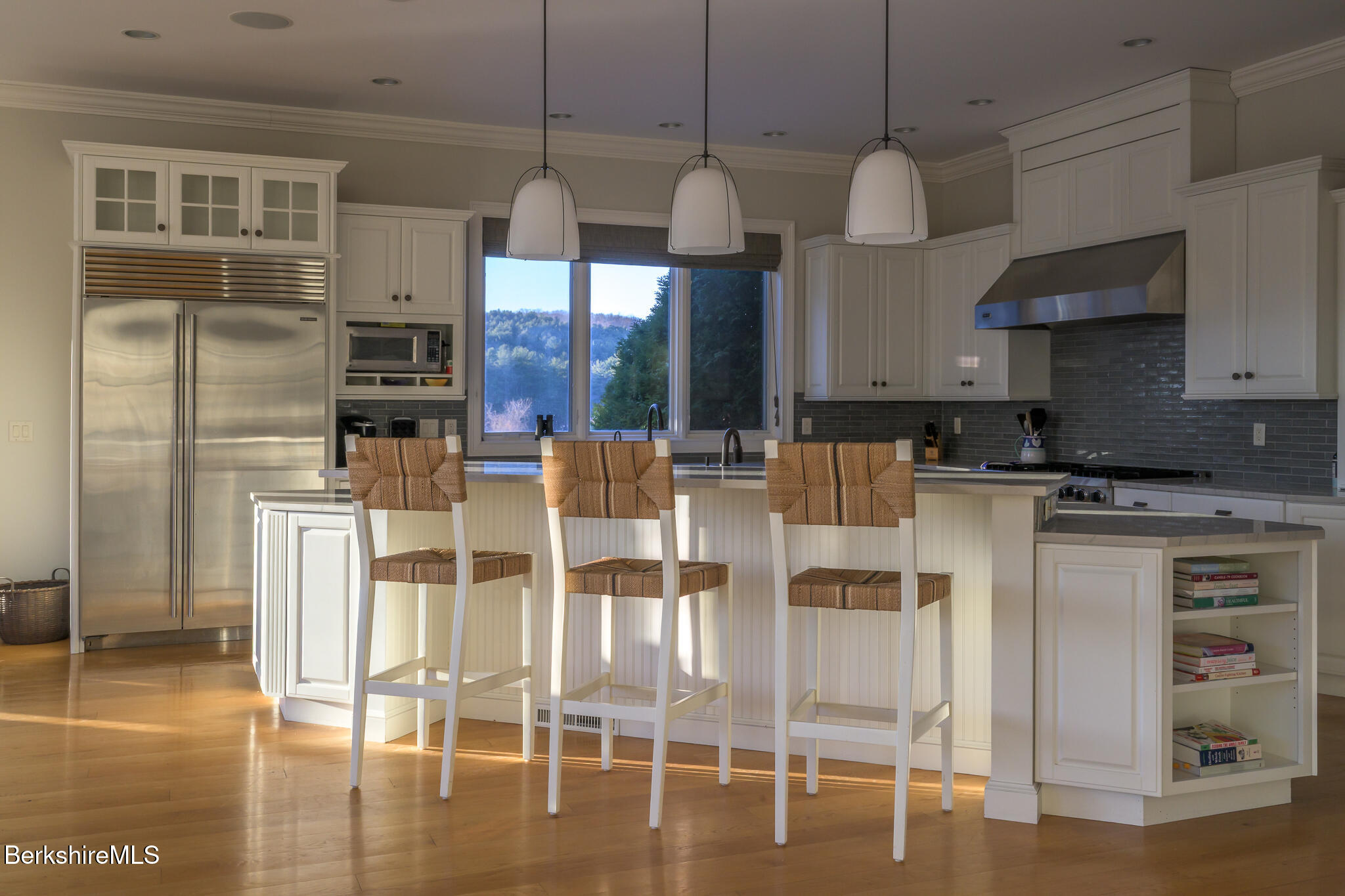 58 Round Hill Road Great Barrington, MA 01230 - Photo 25 of 79 a kitchen with stainless steel appliances granite countertop a stove top oven a refrigerator and white cabinets with wooden floor
