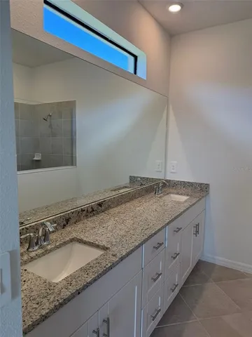 a bathroom with a granite countertop sink and a granite