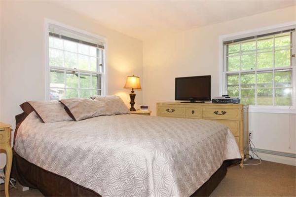 66 Eaton Road Framingham, MA 01701 - Photo 8 of 12 a bedroom with a bed and a flat tv screen on a dresser