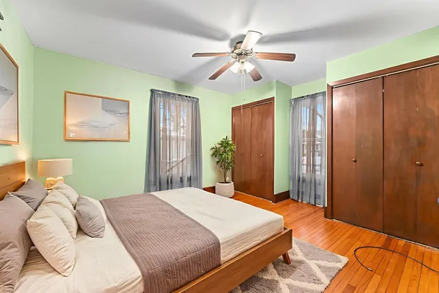 a bedroom with a large bed and a chandelier