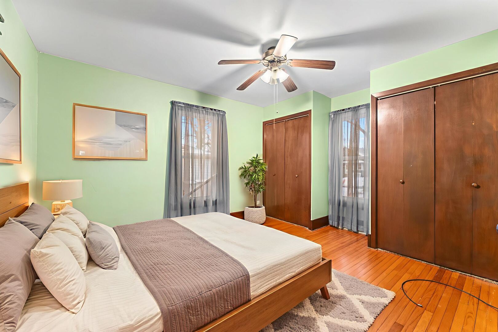 107 East Liberty Street Joy, IL 61260 - Photo 12 of 19 a bedroom with a large bed and a chandelier