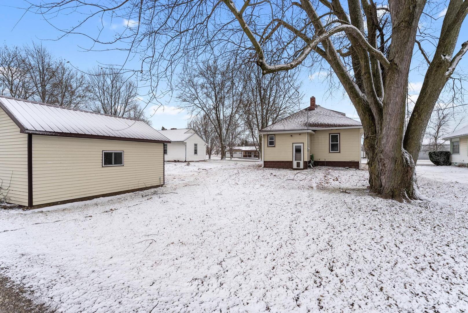 107 East Liberty Street Joy, IL 61260 - Photo 2 of 19 a house that has a tree in front of it