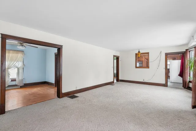 an empty room with windows and closet