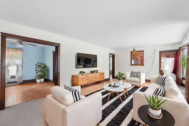 a living room with furniture and a wooden floor