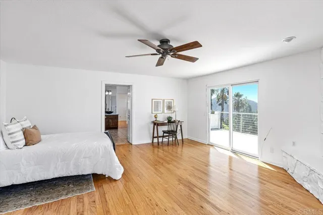 a spacious bathroom with a granite countertop tub sink a mirror a shower and vanity