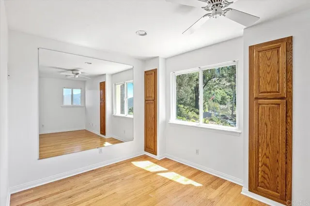 a view of a roof deck with couches and sky view