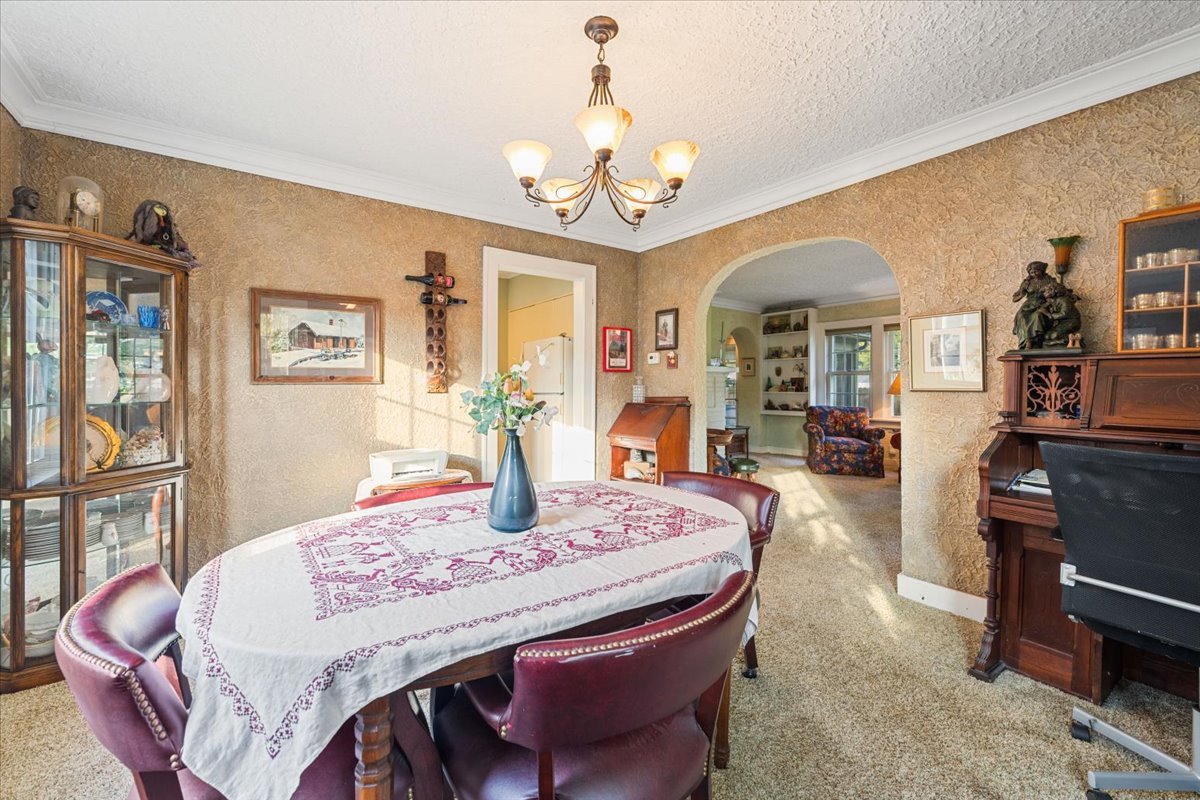 501 Dodson Street Geneva, IL 60134 - Photo 6 of 23 a dining room with wooden floor a chandelier a wooden table and chairs