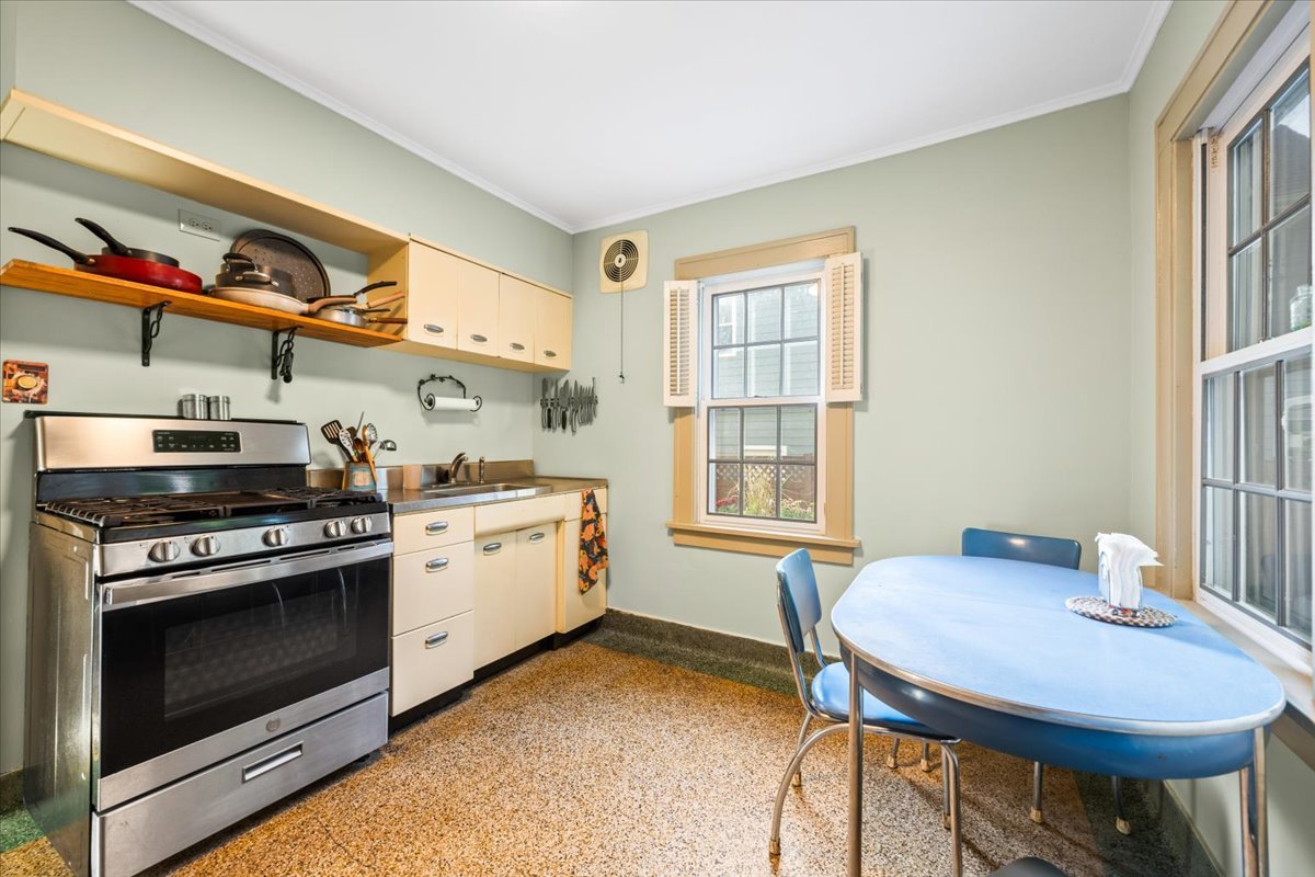 501 Dodson Street Geneva, IL 60134 - Photo 8 of 23 a kitchen with a stove a sink and a dining table