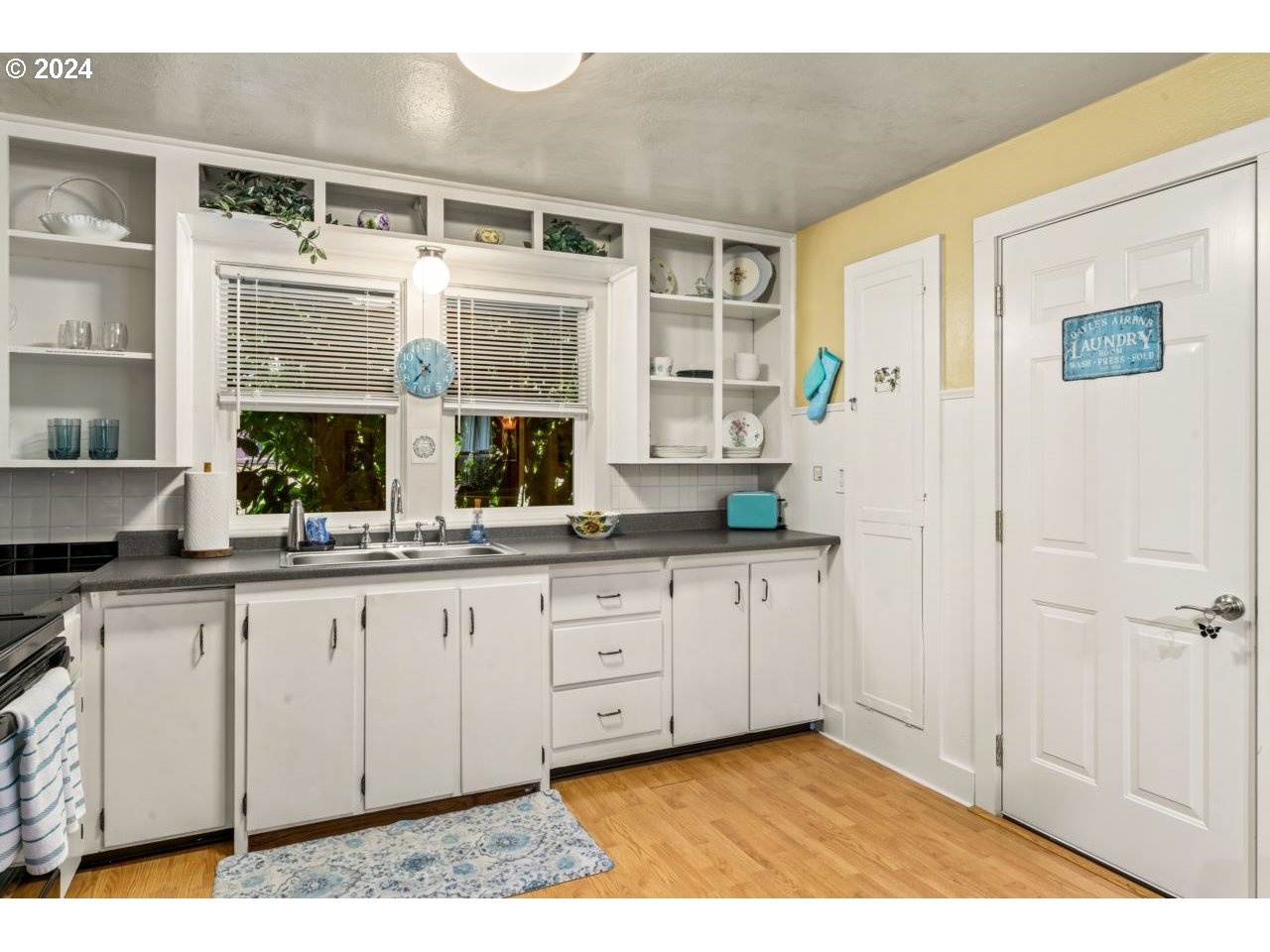 1040 Jefferson Street Eugene, OR 97402 - Photo 4 of 36 a hall with kitchen island granite countertop white cabinets and white appliances