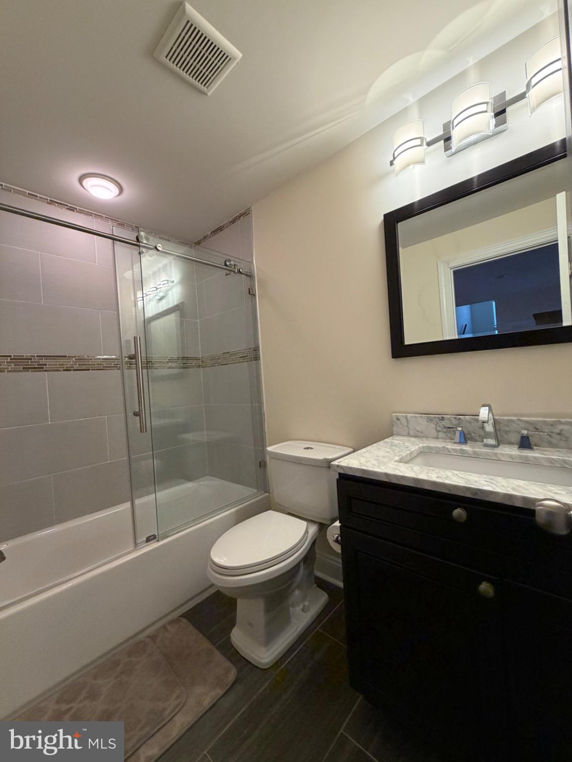 7804 Large Street Philadelphia, PA 19152 - Photo 13 of 42 a bathroom with a sink toilet a mirror and shower