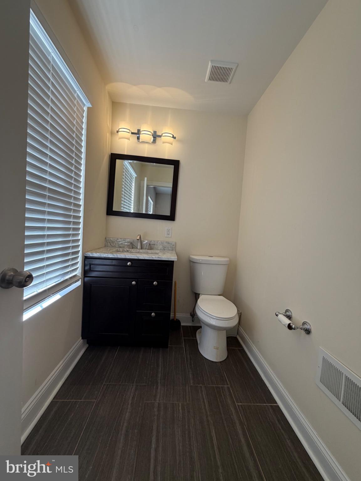 7804 Large Street Philadelphia, PA 19152 - Photo 28 of 42 a bathroom with a toilet sink and mirror