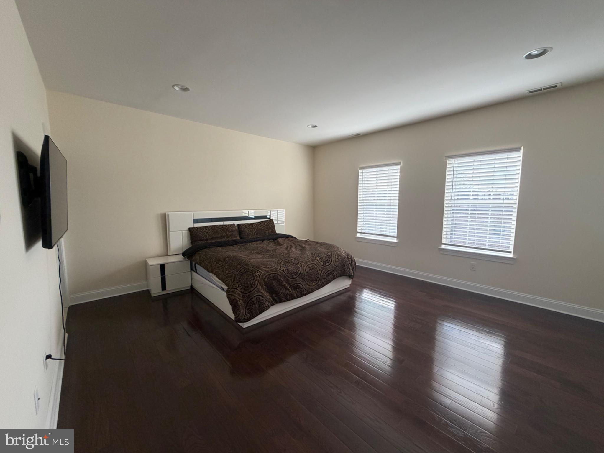 7804 Large Street Philadelphia, PA 19152 - Photo 34 of 42 a bedroom with a bed and flat tv screen on the dresser