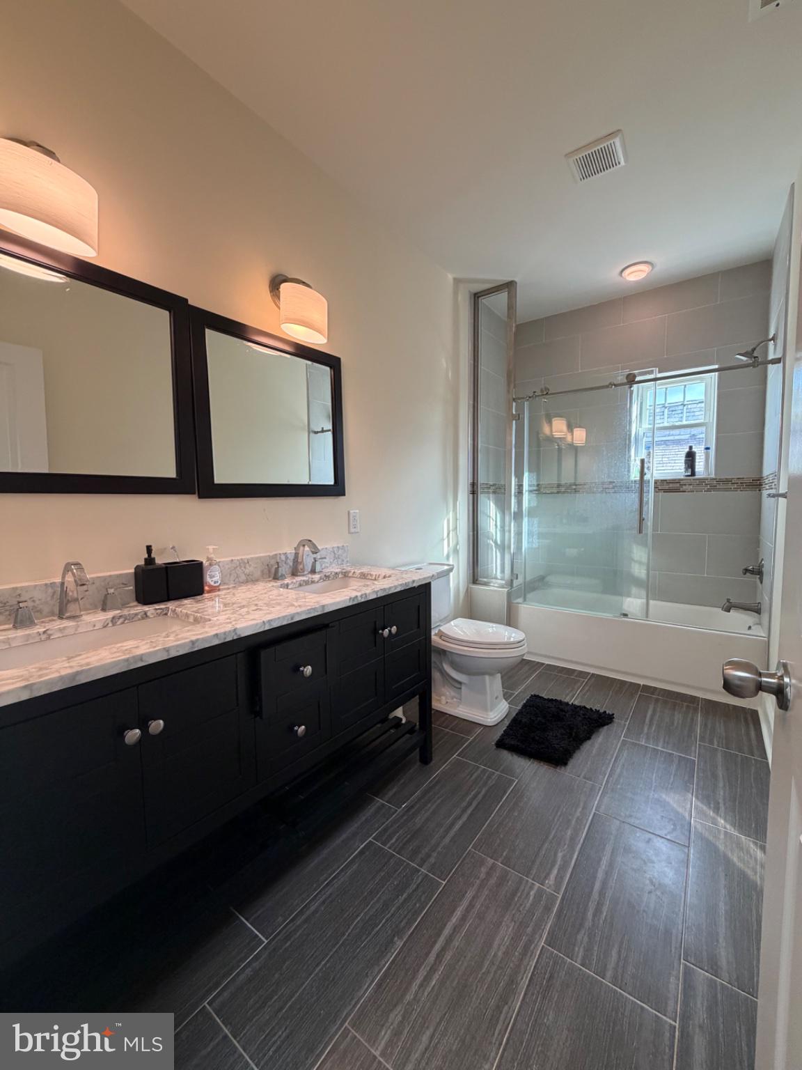 7804 Large Street Philadelphia, PA 19152 - Photo 42 of 42 a spacious bathroom with double vanity and a mirror