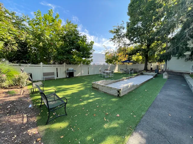a view of a backyard with sitting area