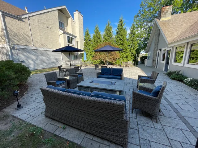 a view of a patio with a table and chairs under an umbrella