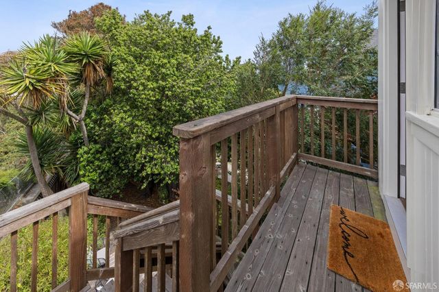 a view of backyard with seating space and trees
