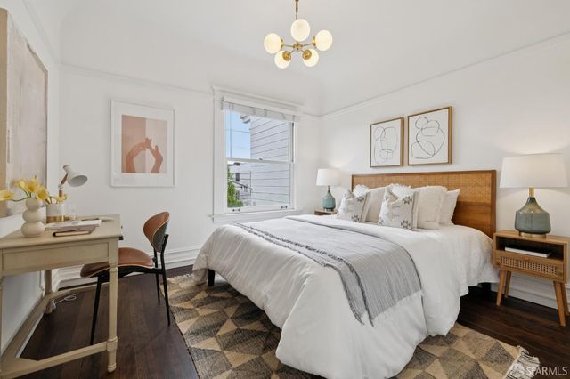 a bedroom with a bed and a chandelier