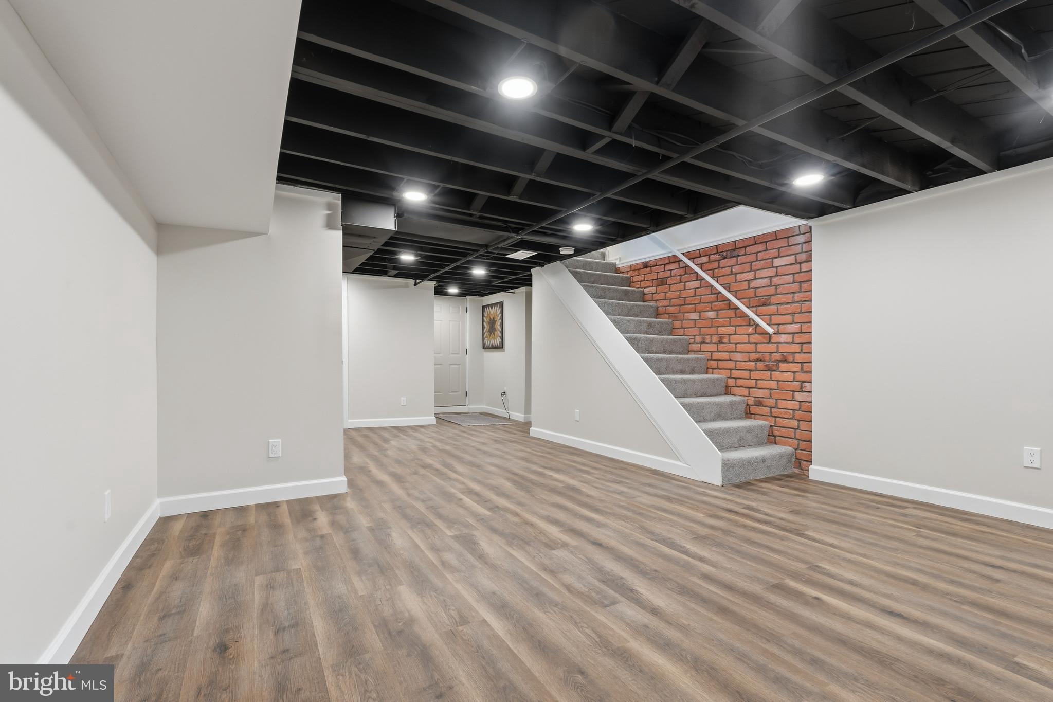 1326 Tompkins Street Baltimore, MD 21225 - Photo 12 of 34 a view of an empty room with wooden floor