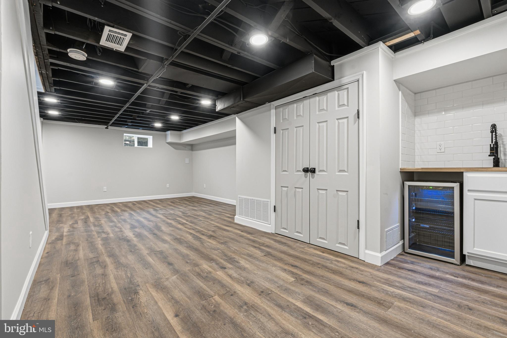 1326 Tompkins Street Baltimore, MD 21225 - Photo 14 of 34 a view of empty room with wooden floor and fireplace