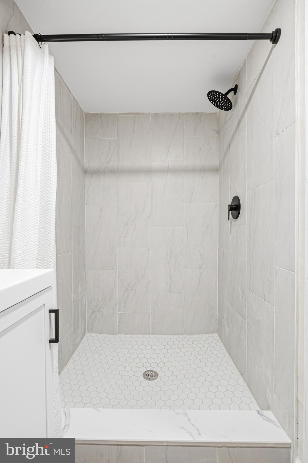 1326 Tompkins Street Baltimore, MD 21225 - Photo 16 of 34 a bathroom with a shower and a bath tub