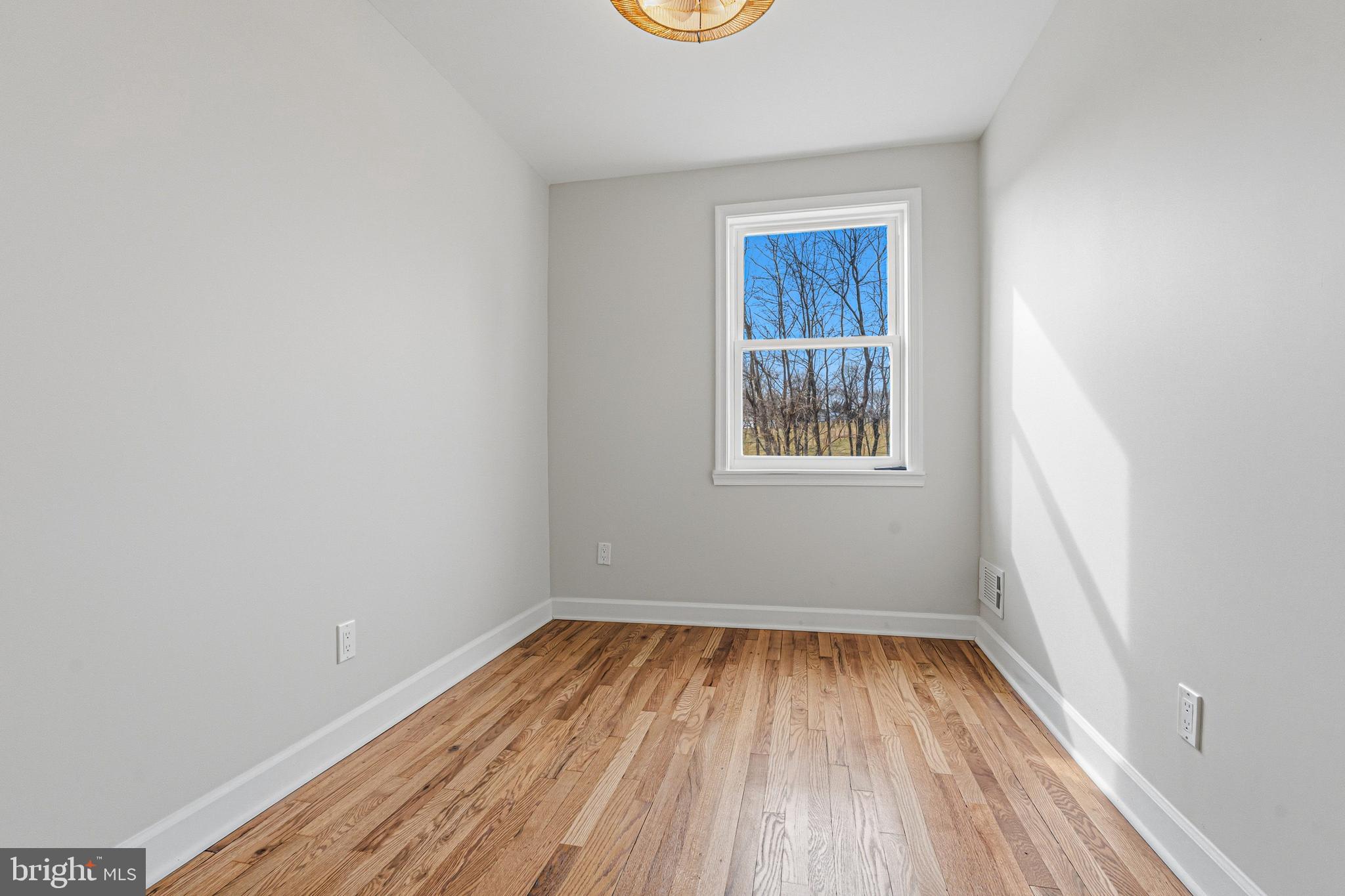1326 Tompkins Street Baltimore, MD 21225 - Photo 23 of 34 a view of a room that has a window and wooden floor