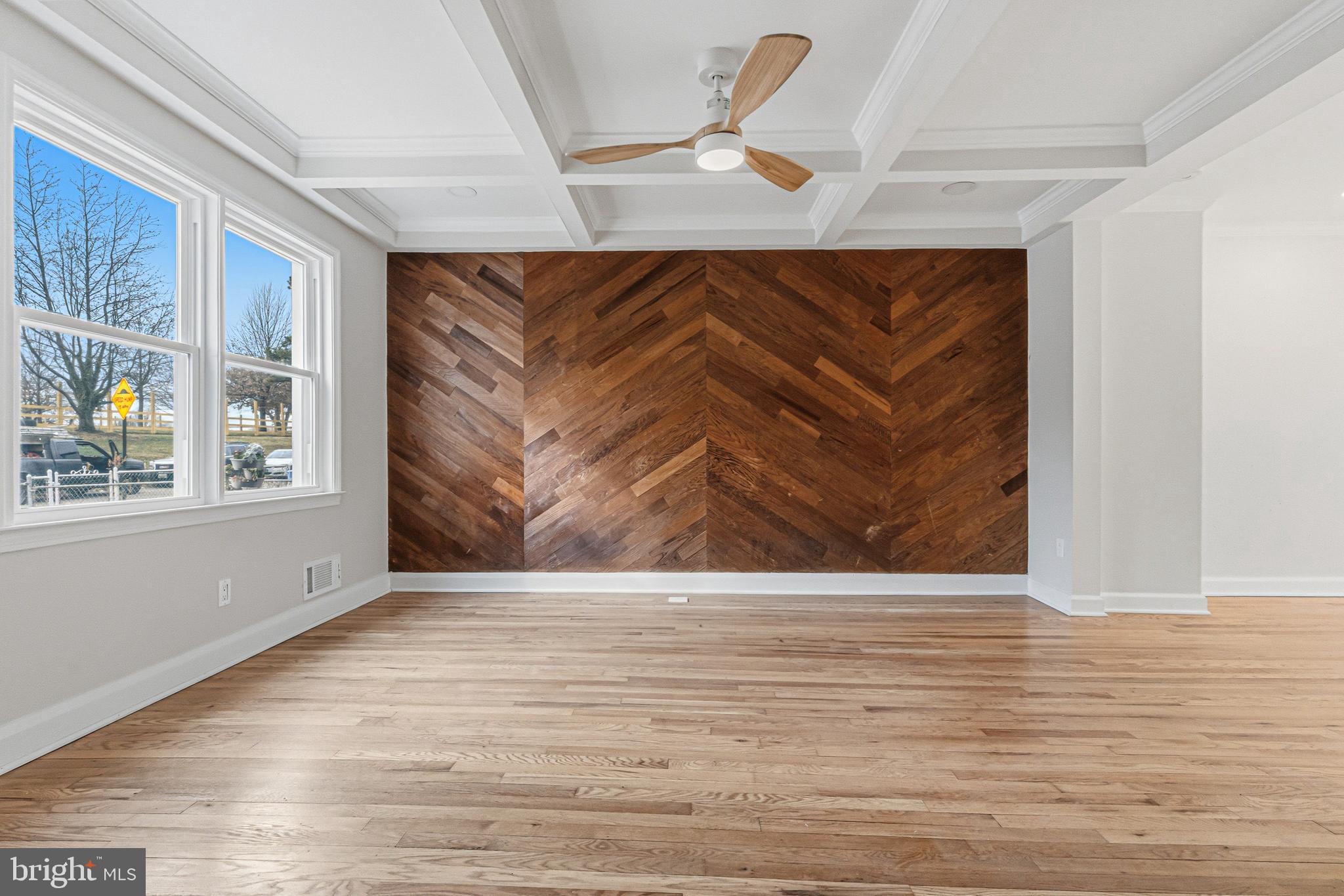 1326 Tompkins Street Baltimore, MD 21225 - Photo 4 of 34 a view of an empty room with wooden floor and a window