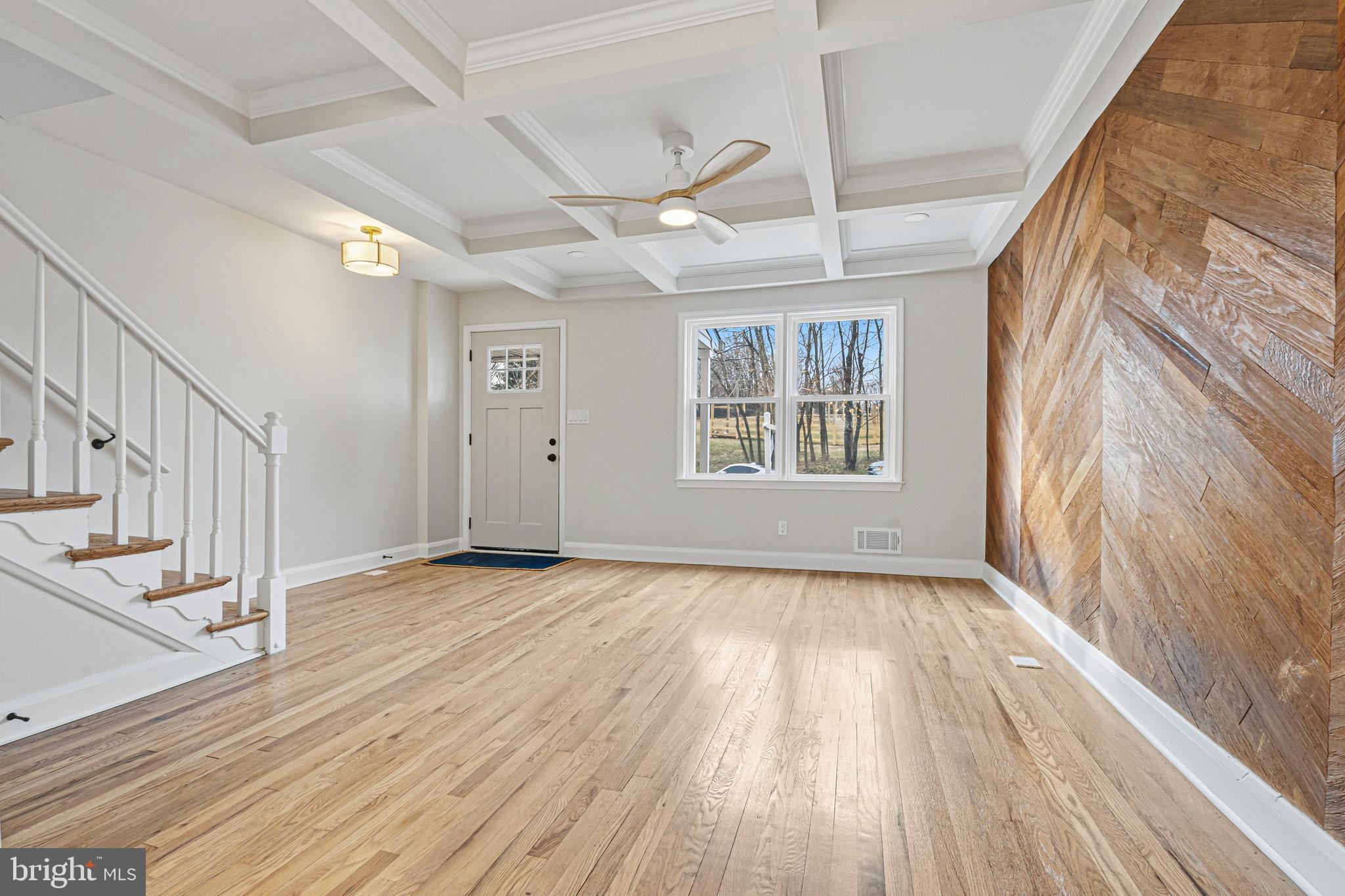 1326 Tompkins Street Baltimore, MD 21225 - Photo 5 of 34 a view of an empty room with wooden floor and a window