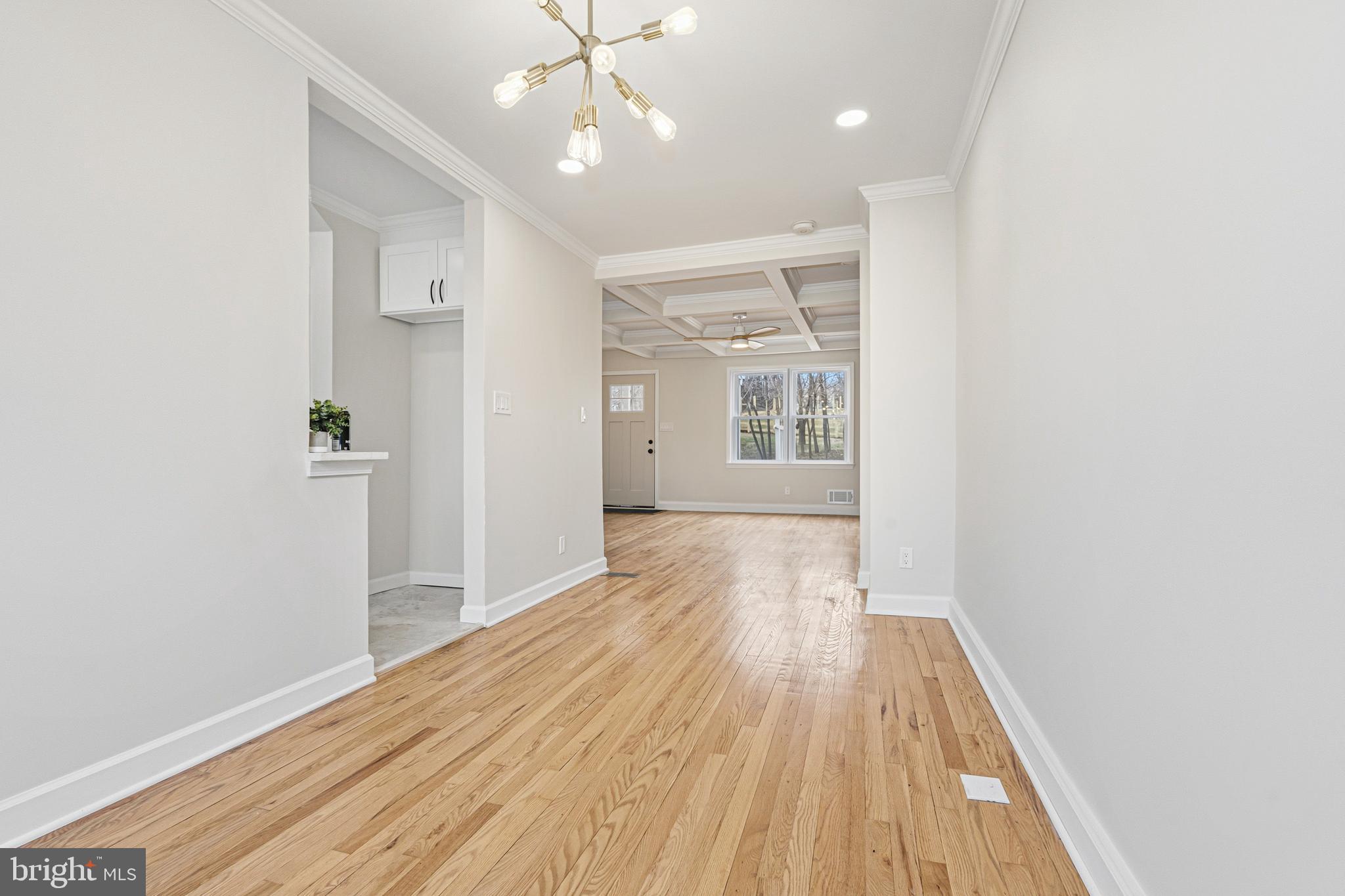 1326 Tompkins Street Baltimore, MD 21225 - Photo 7 of 34 wooden floor in an empty room with a window