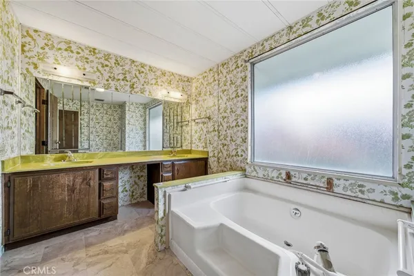 a spacious bathroom with a bathtub and a sink