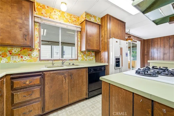 a kitchen with stainless steel appliances kitchen island granite countertop a sink and cabinets