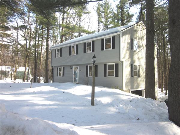 386 Taylor Road Stow, MA 01775 - Photo 1 of 1 a front view of a house with a yard and garage