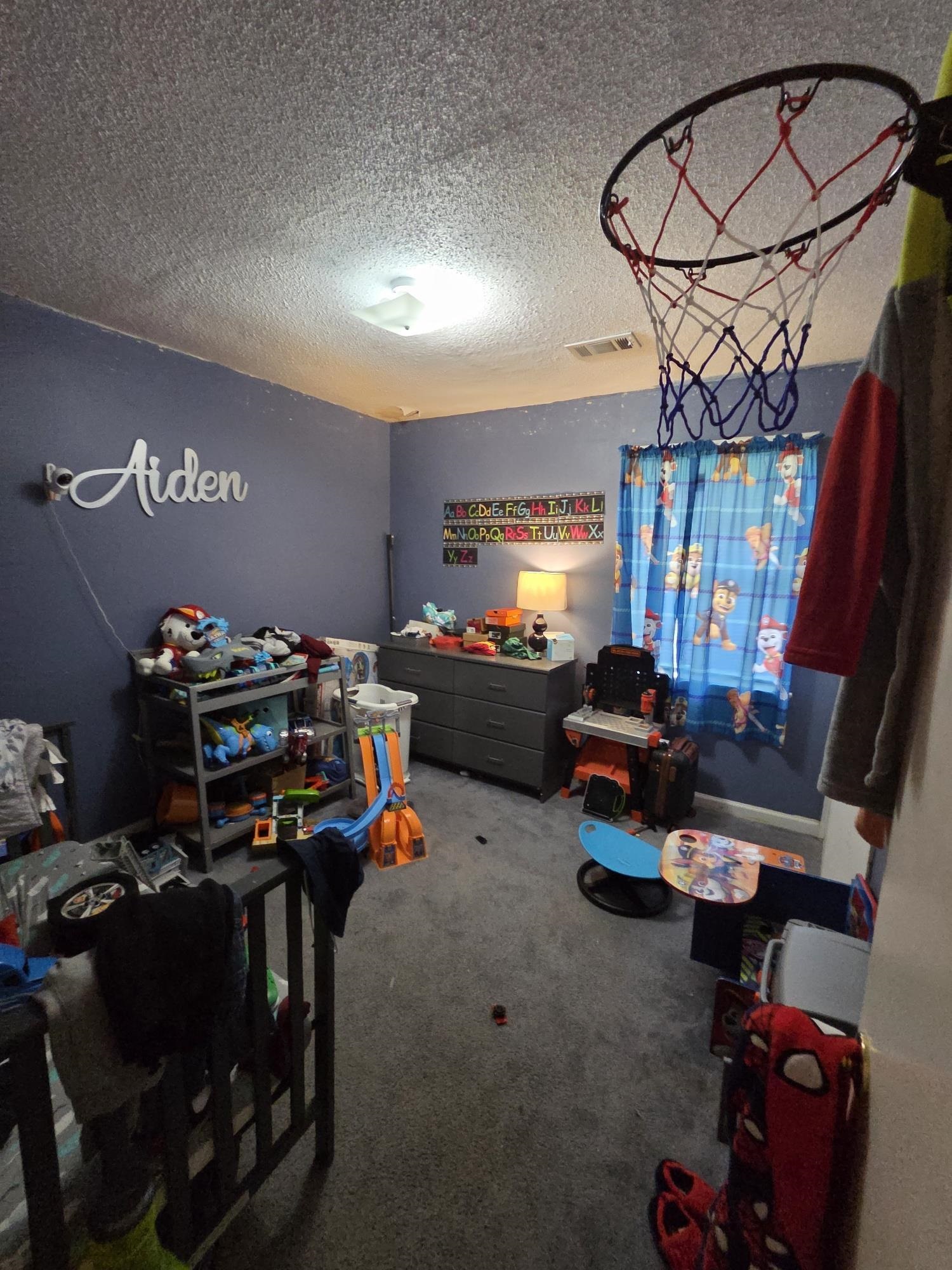 899 West Raines Road Memphis, TN 38109 - Photo 7 of 10 Carpeted room with a ceiling-mounted light fixture and light blue painted walls