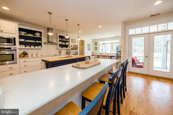 a kitchen with sink stove and cabinets