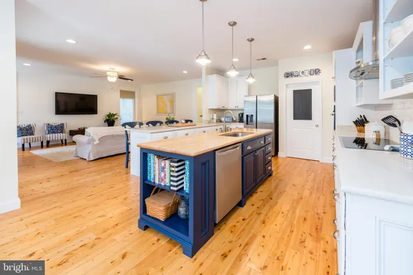 a kitchen with stainless steel appliances granite countertop a stove and a microwave