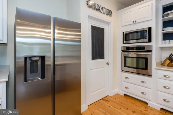 a kitchen with stainless steel appliances kitchen island granite countertop a sink and cabinets