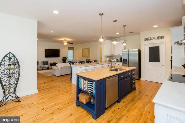 a bedroom with a bed and a flat tv screen on dresser