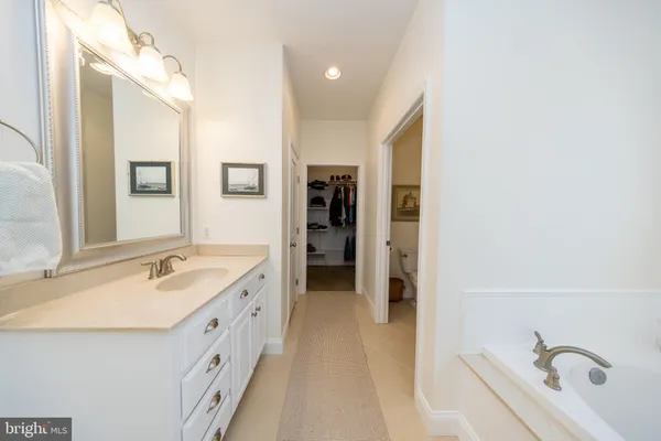 a bathroom with a double vanity sink toilet and mirror