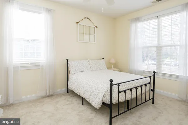 a bathroom with a granite countertop toilet and sink