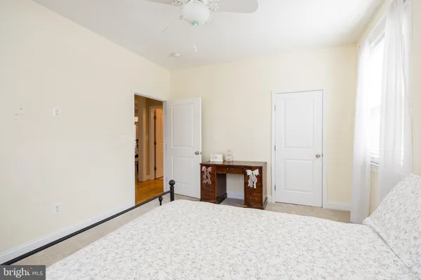 a bedroom with a bed and a desk