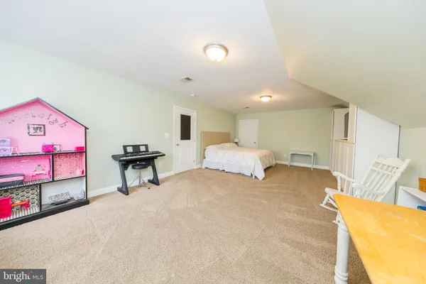 a view of a white house with a yard in the background