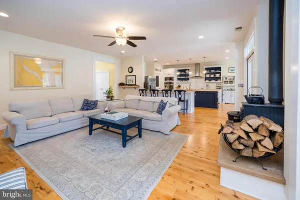 a large kitchen with kitchen island granite countertop lots of counter top space a sink and stainless steel appliances