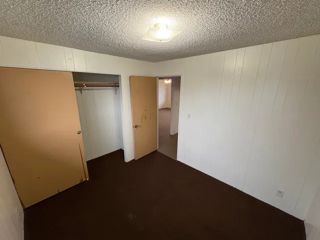 an empty room with closet area
