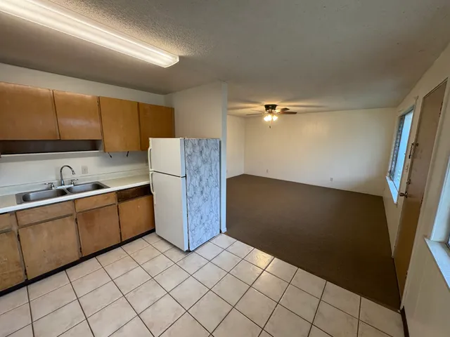 a kitchen with a sink window and cabinets