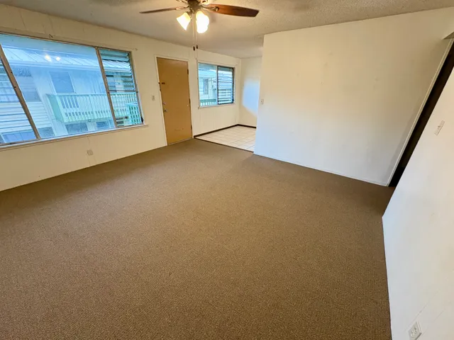 an empty room with windows and entrance