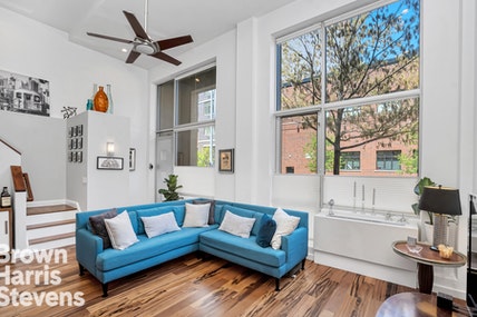 2-40 51st Avenue, Unit 1F Queens, NY 11101 - Photo 1 of 1 a living room with furniture and a large window