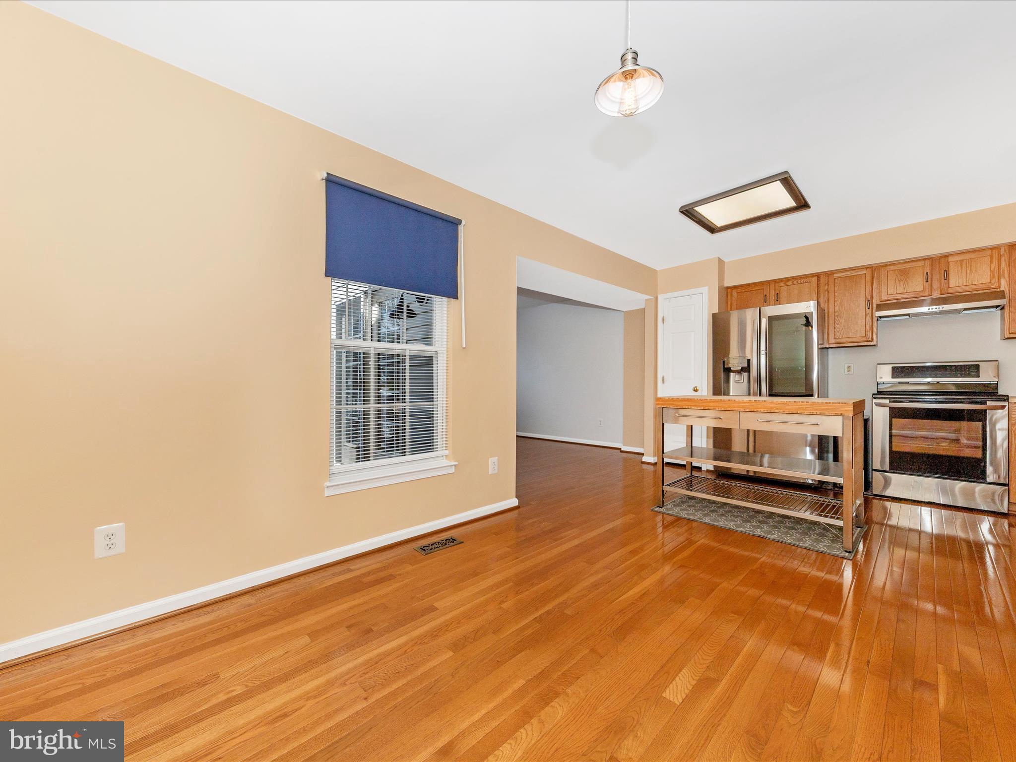 1351 Mare Street Ranson, WV 25438 - Photo 12 of 52 a living room with stainless steel appliances kitchen island granite countertop a stove and a wooden cabinets