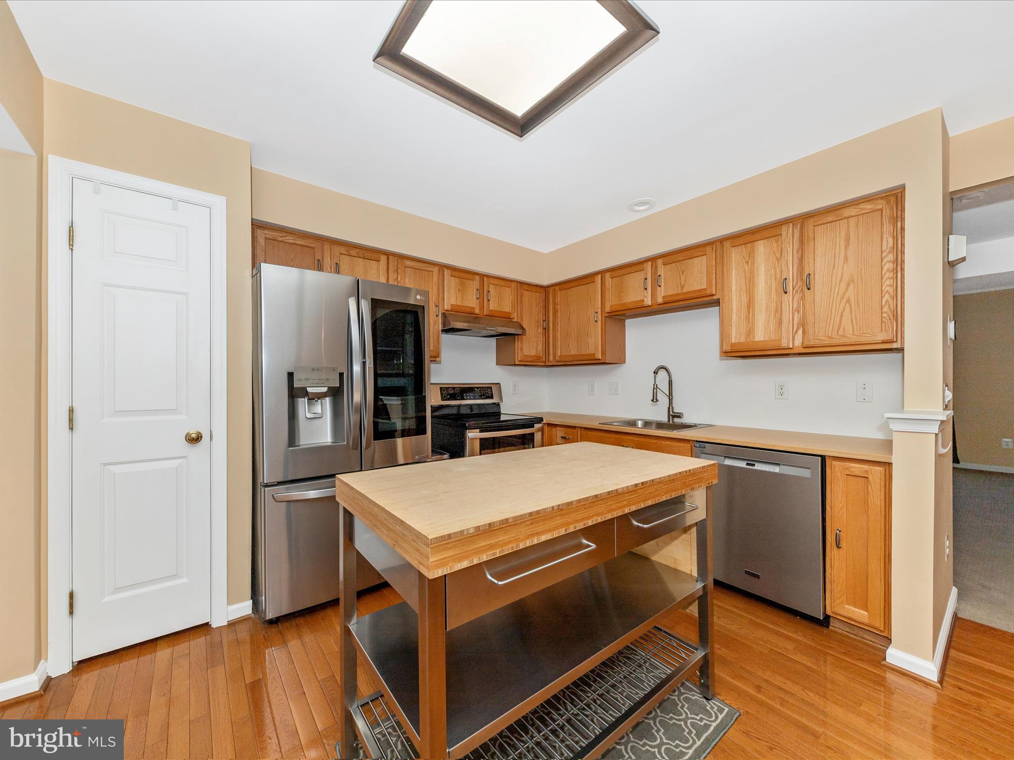 1351 Mare Street Ranson, WV 25438 - Photo 14 of 52 a kitchen with a stove a refrigerator and wooden floor