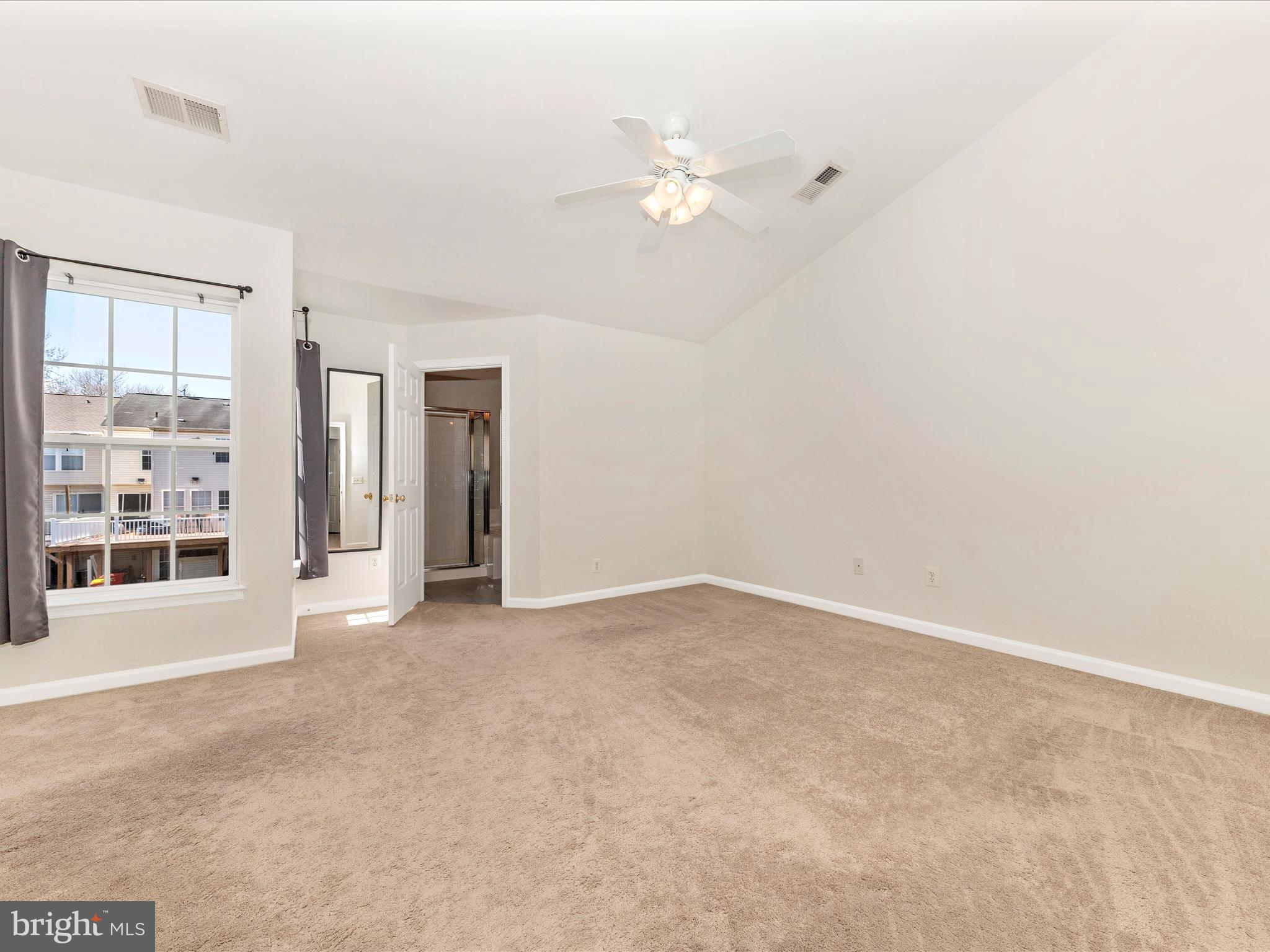 1351 Mare Street Ranson, WV 25438 - Photo 28 of 52 an empty room with chandelier fan and windows